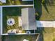 Aerial view of a home with fire pit and storage shed at 5864 Mckee Lake N Dr, St Petersburg, FL 33709