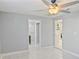 This bedroom features light tiling and ceiling fan at 5864 Mckee Lake N Dr, St Petersburg, FL 33709