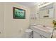 Small bathroom with white vanity and toilet at 6020 Shore S Blvd # 101, Gulfport, FL 33707