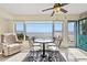 Cozy dining space with waterfront views and a charming teal door at 6020 Shore S Blvd # 101, Gulfport, FL 33707