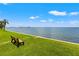 Serene waterfront park with bench and lush grass at 6020 Shore S Blvd # 101, Gulfport, FL 33707