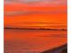 Fiery red sunset over the water, city skyline on horizon at 6020 Shore S Blvd # 101, Gulfport, FL 33707