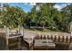 Waterfront home with private dock, lift and lush foliage on a sunny day at 664 Geneva Pl, Tampa, FL 33606