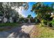 Charming single-story home featuring a well-maintained front lawn and a convenient covered carport and a driveway at 664 Geneva Pl, Tampa, FL 33606