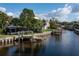 Serene waterfront property with a private boat dock and lush landscaping at 664 Geneva Pl, Tampa, FL 33606