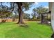 Expansive backyard features lush green grass, privacy fencing, and mature trees at 705 W Kentucky Ave, Tampa, FL 33603