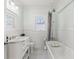 Bright bathroom features a vanity with sink, white subway tile, hexagon tile floor and a frosted window at 705 W Kentucky Ave, Tampa, FL 33603