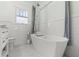 Bright bathroom features a freestanding tub, white subway tile, hexagon tile floor and a frosted window at 705 W Kentucky Ave, Tampa, FL 33603