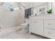 Bright bathroom featuring a glass shower, and white vanity with marble countertop at 705 W Kentucky Ave, Tampa, FL 33603