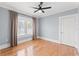 Bedroom with a ceiling fan, window with curtains and hardwood floors at 705 W Kentucky Ave, Tampa, FL 33603