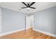 Light-filled bedroom featuring hardwood floors, neutral paint, a ceiling fan and white trim at 705 W Kentucky Ave, Tampa, FL 33603