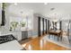 Bright, modern kitchen and dining area featuring stainless appliances and hardwood floors at 705 W Kentucky Ave, Tampa, FL 33603