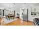 Open concept kitchen with stainless steel appliances, dining area, and chandelier at 705 W Kentucky Ave, Tampa, FL 33603