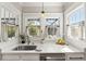 Sunlit kitchen sink area with a stainless steel sink and quartz countertops at 705 W Kentucky Ave, Tampa, FL 33603