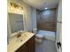 Updated bathroom with tile shower and wood vanity at 8014 N Alaska St, Tampa, FL 33604