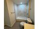 Renovated bathroom featuring marble-look tile and a bathtub at 8014 N Alaska St, Tampa, FL 33604