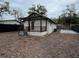 Rear view of house with a pergola and small yard at 8014 N Alaska St, Tampa, FL 33604