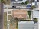 Aerial view of a house with a brown roof, backyard, and surrounding buildings at 834 11Th N St, St Petersburg, FL 33705