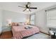 Spacious bedroom with pink bedding, ceiling fan, and hardwood floors at 834 11Th N St, St Petersburg, FL 33705