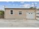 Detached garage with a white roll-up door at 834 11Th N St, St Petersburg, FL 33705