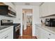 Bright kitchen with view into living room and hardwood floors at 834 11Th N St, St Petersburg, FL 33705