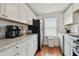 Modern kitchen with white cabinets, granite counters, and stainless steel appliances at 834 11Th N St, St Petersburg, FL 33705