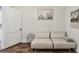 Cozy living room featuring a light beige couch and wood-look floors at 834 11Th N St, St Petersburg, FL 33705