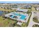 Aerial view of community pool with lounge seating surrounded by lush landscaping at 8463 Canyon Creek Trl, Parrish, FL 34219