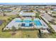 Aerial view of community pool with palms and lounge seating and lush landscaping at 8463 Canyon Creek Trl, Parrish, FL 34219