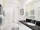 Well-lit bathroom with shower/tub, black countertop, and tasteful decor at 8463 Canyon Creek Trl, Parrish, FL 34219