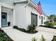 Charming home featuring an inviting front porch and two car garages, accented by an American flag at 8463 Canyon Creek Trl, Parrish, FL 34219