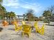 Outdoor fire pit area surrounded by Adirondack chairs and lush landscaping at 8463 Canyon Creek Trl, Parrish, FL 34219