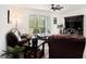 Comfortable living room featuring a leather sofa, ceiling fan, and a view to the screened lanai at 8463 Canyon Creek Trl, Parrish, FL 34219