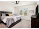 Bright main bedroom featuring neutral walls, carpet, and a ceiling fan at 8463 Canyon Creek Trl, Parrish, FL 34219