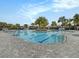 Resort-style community pool with palm trees, gray brick patio, and crystal-clear water under a bright, partly cloudy sky at 8463 Canyon Creek Trl, Parrish, FL 34219