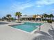 Community pool featuring a sun deck, palm trees, and lounge seating at 8463 Canyon Creek Trl, Parrish, FL 34219