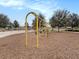 Community playground with swing set area located near walking paths in a bark-mulched area and shaded by mature trees at 8463 Canyon Creek Trl, Parrish, FL 34219