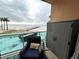 Relaxing balcony with ocean view, seating, and storage at 880 Mandalay Ave # N111, Clearwater Beach, FL 33767