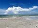 Expansive beach view with blue sky and clouds at 880 Mandalay Ave # N111, Clearwater Beach, FL 33767