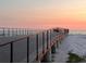 Wooden boardwalk over the sand leading to the ocean at sunset at 880 Mandalay Ave # N111, Clearwater Beach, FL 33767