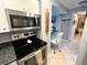 Eat-in kitchen with stainless steel range and microwave at 880 Mandalay Ave # N111, Clearwater Beach, FL 33767