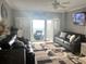 Living room with leather sofas and access to balcony at 880 Mandalay Ave # N111, Clearwater Beach, FL 33767