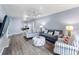 Living room with gray couches, striped chairs, and wood floors at 9206 Bella Terraza Way, Temple Terrace, FL 33617