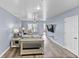 Living room with gray couches, striped chairs, and wood floors at 9206 Bella Terraza Way, Temple Terrace, FL 33617