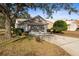 House exterior showcasing a two-car garage and spacious driveway at 9287 New Orleans Dr, Weeki Wachee, FL 34613