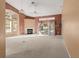 Spacious living room with high ceilings, fireplace, and sliding doors at 9287 New Orleans Dr, Weeki Wachee, FL 34613