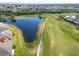 Aerial view showcasing the property's location on a golf course with nearby water and golf cart path at 970 Pembroke Point Way, Sun City Center, FL 33573