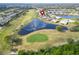 Aerial view showcasing the property's location on a golf course with beautiful water views at 970 Pembroke Point Way, Sun City Center, FL 33573