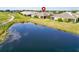 Aerial view of house situated near a pond and lush green spaces, creating a serene atmosphere at 970 Pembroke Point Way, Sun City Center, FL 33573