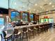 Chic bar area featuring a marble countertop, stylish seating, and large windows with scenic views at 970 Pembroke Point Way, Sun City Center, FL 33573